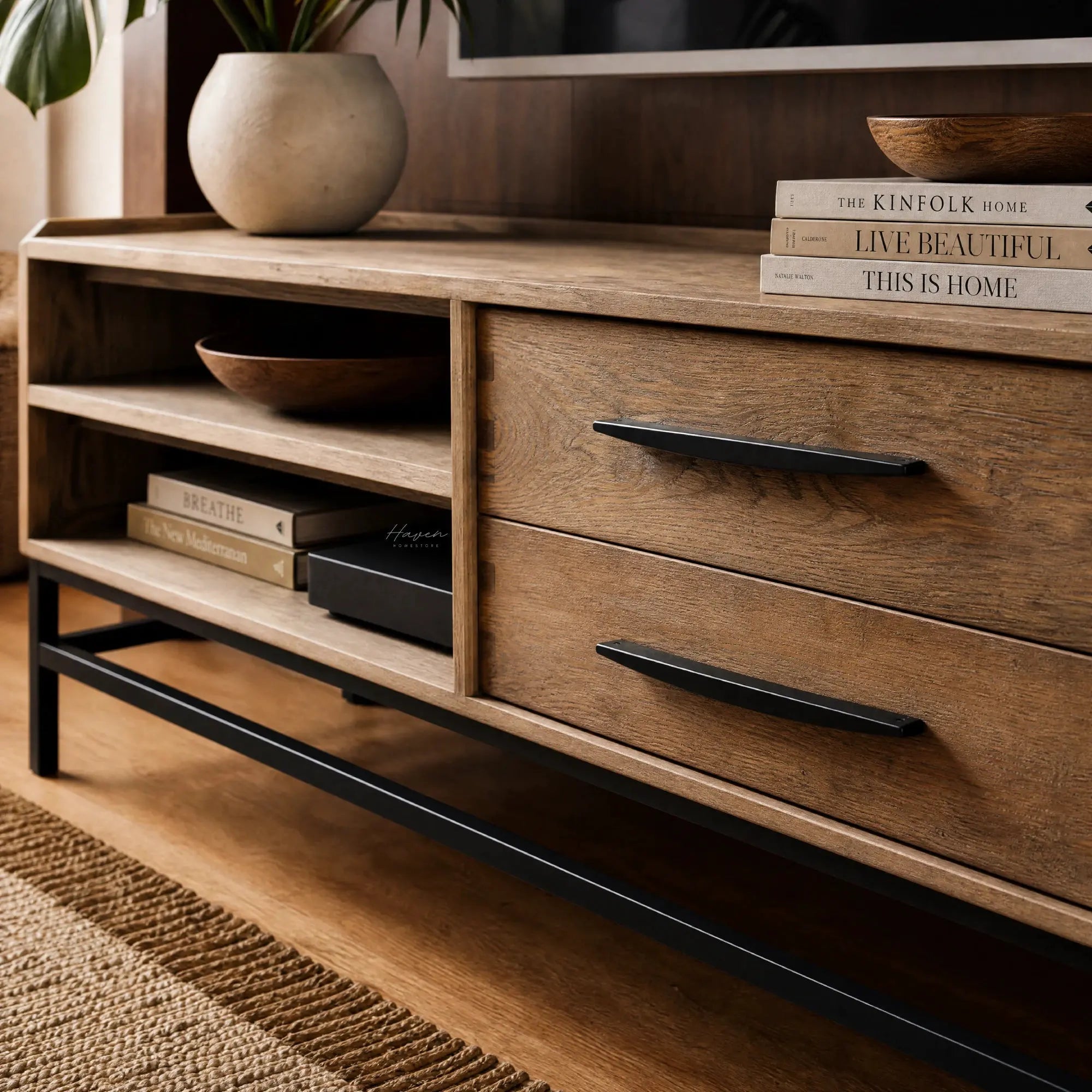 Atlas Entertainment Unit in natural oak with metal detailing, open shelves and drawers, styled with books and bowls.
