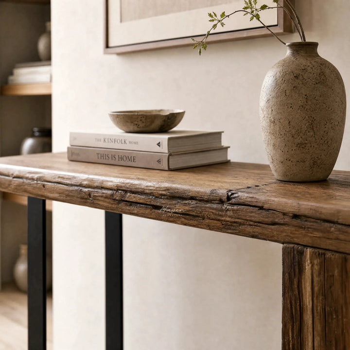 Timberline Reclaimed Console with knotty pine top and steel base, styled with a vase and stacked books.