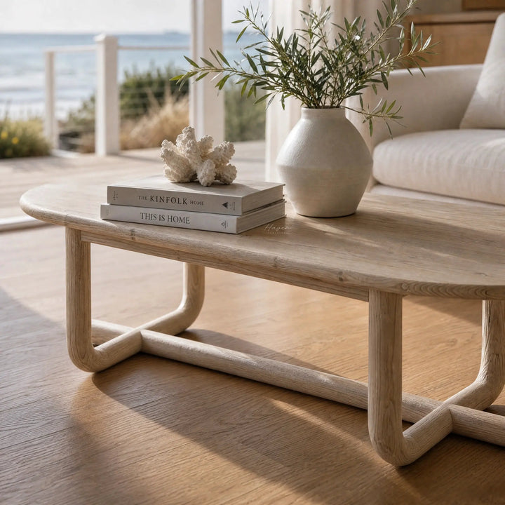 Jones Coffee Table with a chalk-washed finish and curved silhouette in a coastal living room, recycled pine.