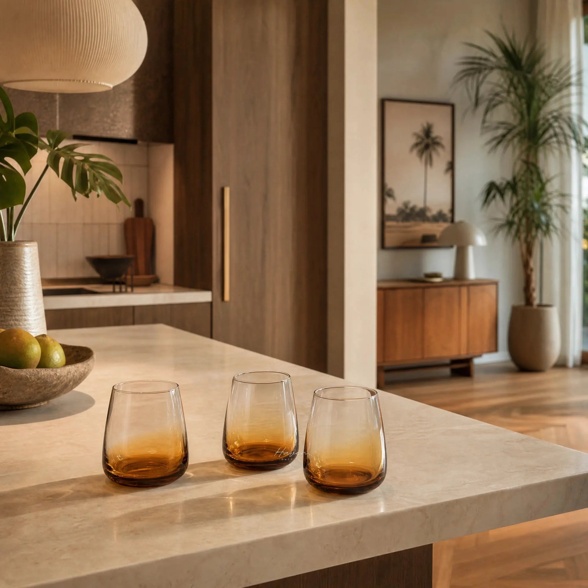 Broste Tumbler Set/8 Amber: eight mouthblown amber tumblers on a marble kitchen island.