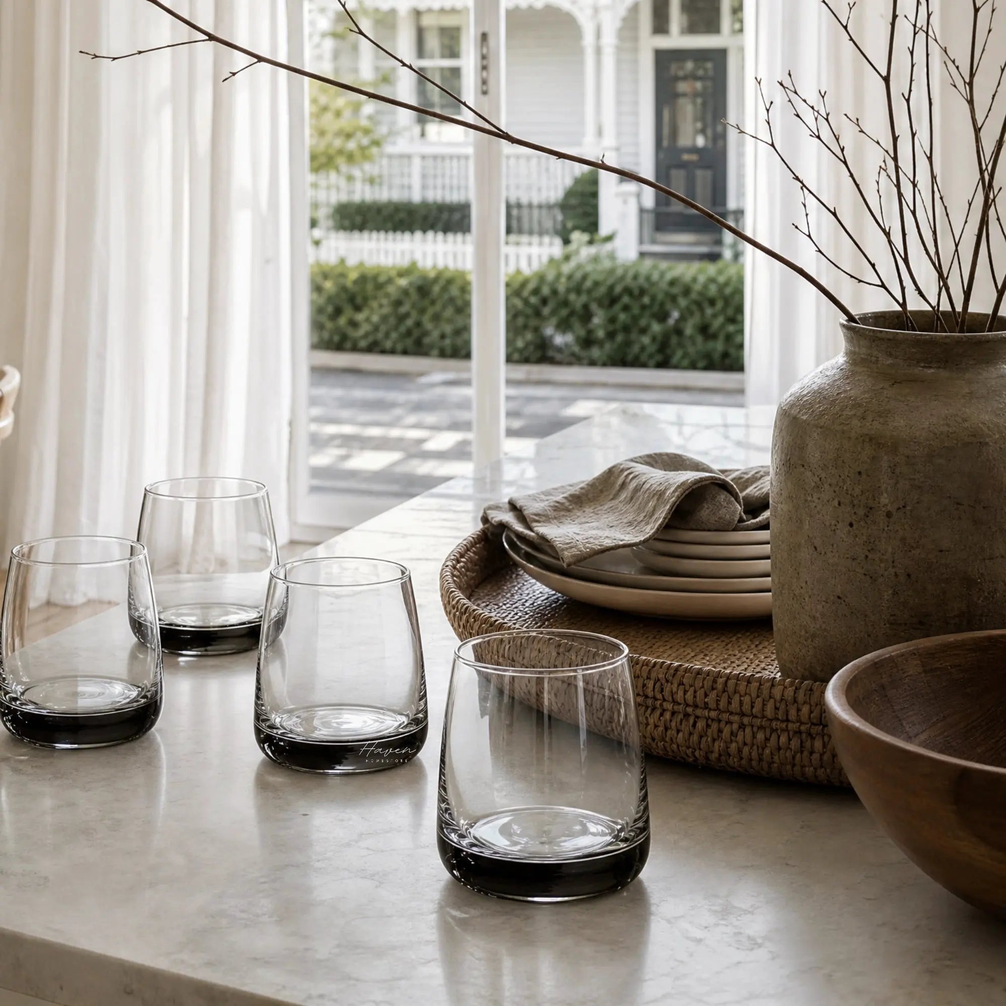Broste Tumbler Set/8 - Smoke: handcrafted glass tumblers with smoky charcoal base on a marble table.