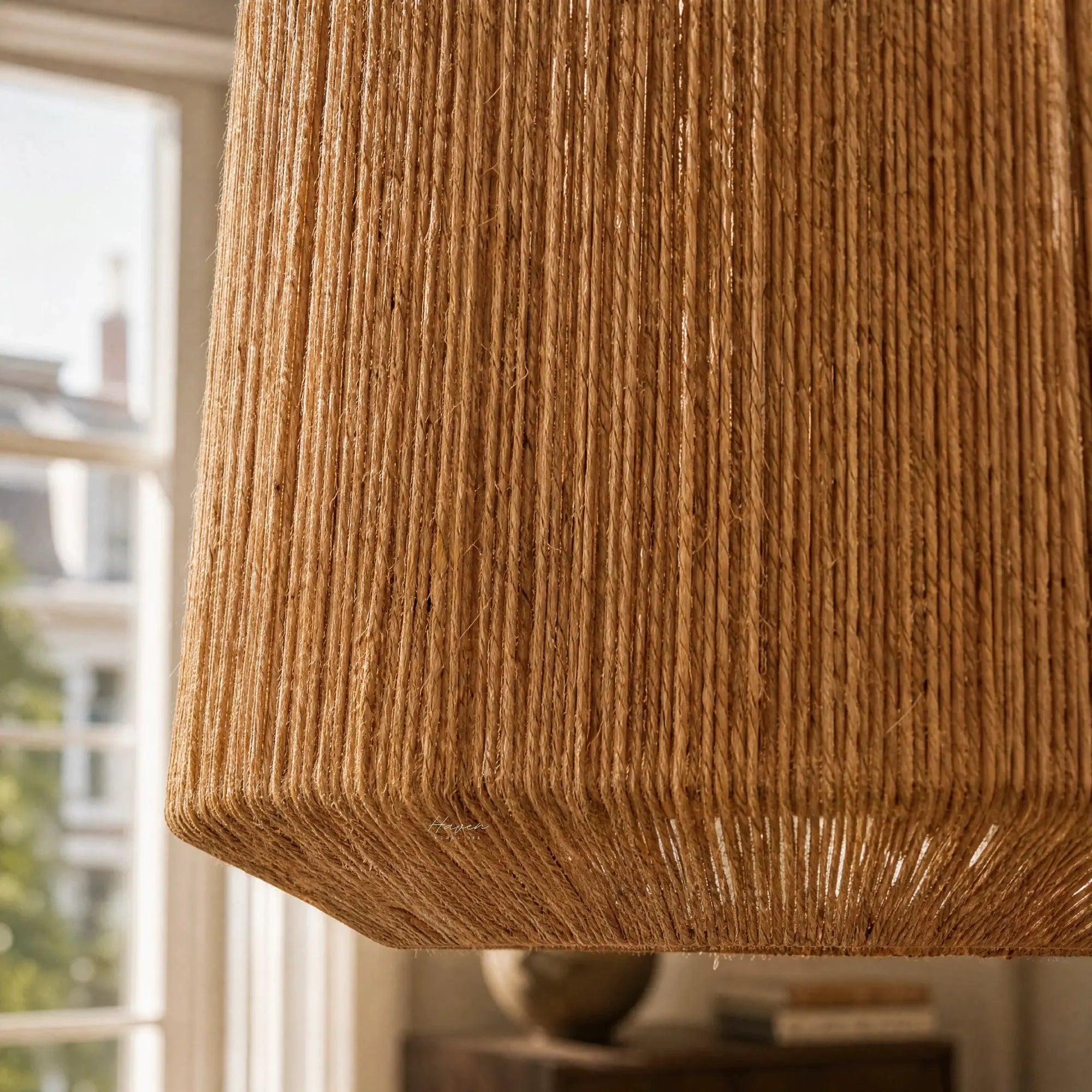 Ren Lampshade in natural jute weave with warm, diffused light.