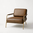 Pure Sinclair Leather Chair in Italian-tanned buffalo leather with a refined brass frame.