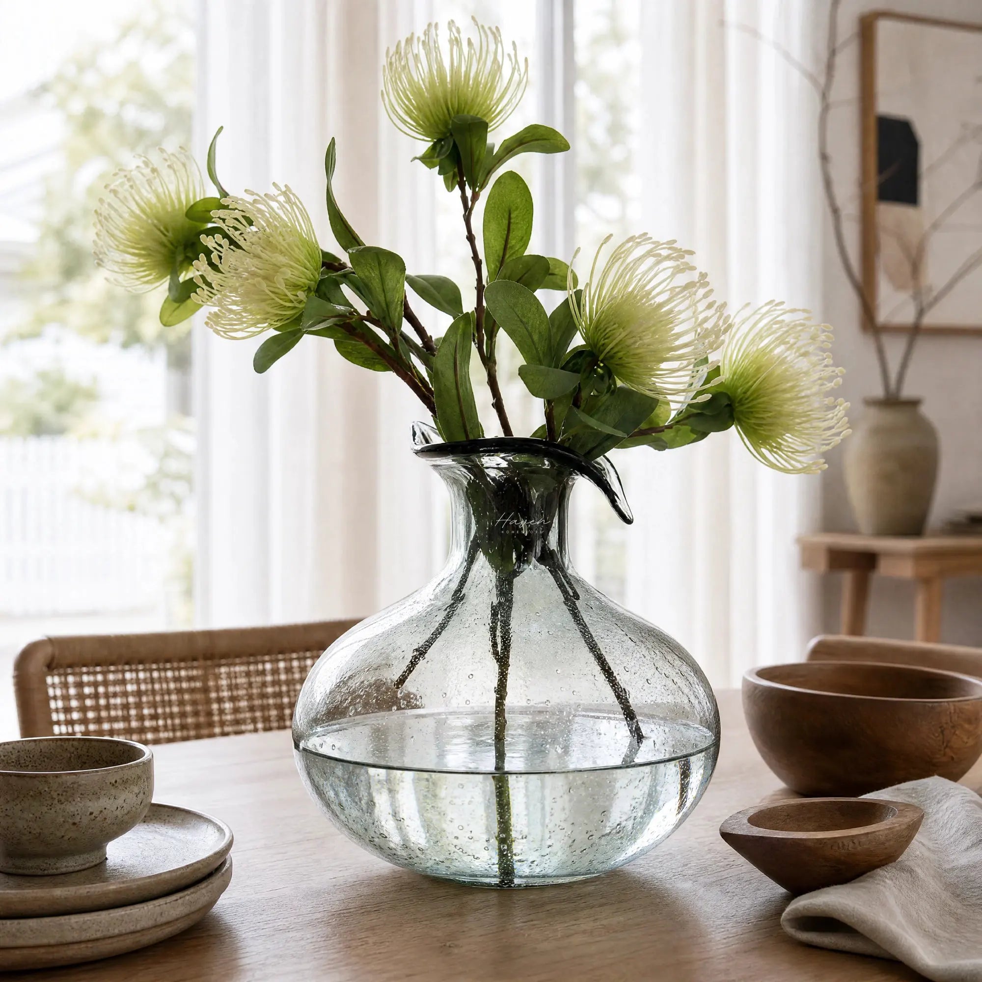 Ingrid Glass Vase in smoky glass with suspended bubbles and a petal-shaped rim, shown with simple stems.