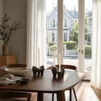 Broste Laia candleholder set of 2 in antique brown glazed ceramic with staggered candle heights on a dining table.