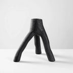 MUUBS Aion Candleholder Set/2 in black cast iron with a tree-branch inspired, three-legged sculptural form