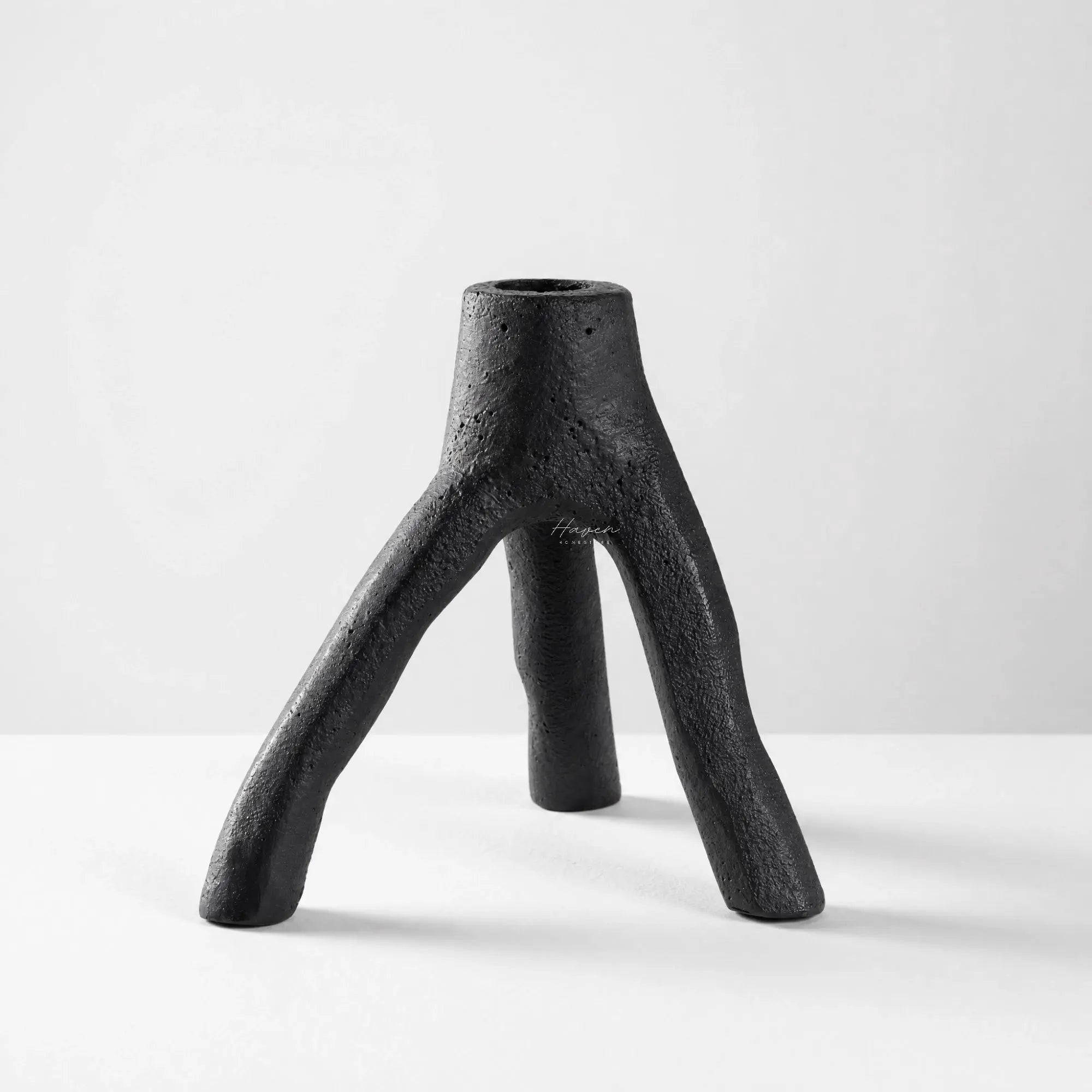 MUUBS Aion Candleholder Set/2 in black cast iron with a tree-branch inspired, three-legged sculptural form