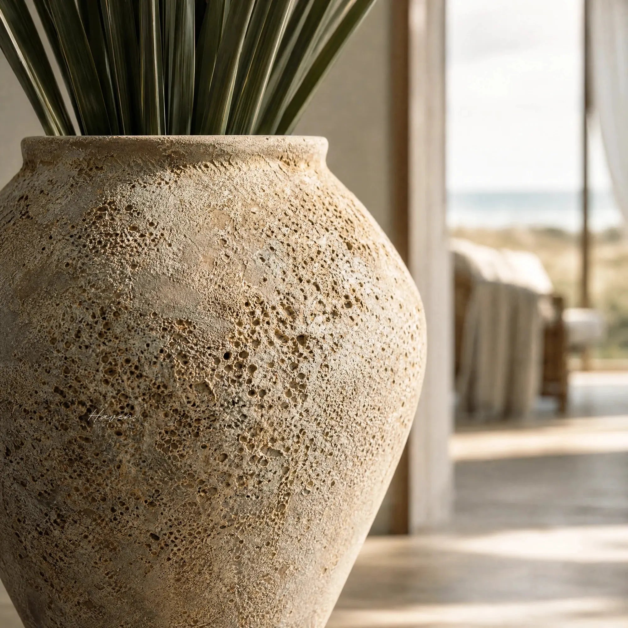 MUUBS Pot Trace 55 in coral/sand with rough porous terracotta surface and green leaves.
