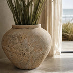 MUUBS Pot Trace 30 Coral/Sand terracotta planter with tall green leaves indoors.