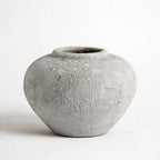 MUUBS Pot Luna 18 - Grey, spherical ceramic pot with cratered texture.