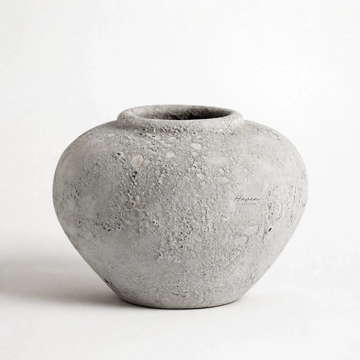 MUUBS Pot Luna 18 - Grey, spherical ceramic pot with cratered texture.