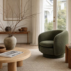 Monika Swivel Chair in olive-green upholstery with a rounded, sculptural form in a cozy living room.