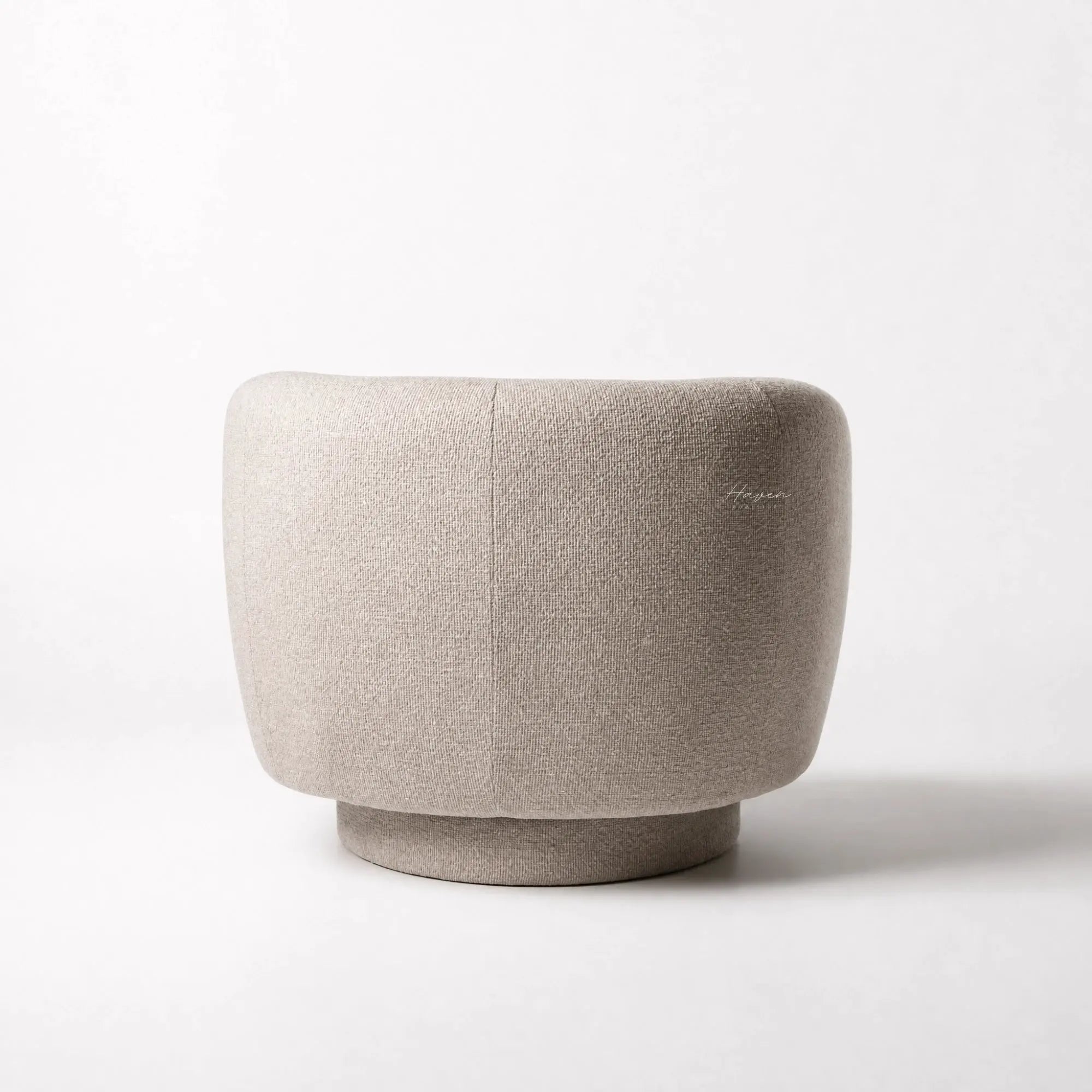 Monika Swivel Chair in Latte fabric with soft sculptural silhouette, curved back, and smooth swivel base.
