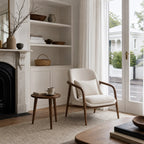 Lund Armchair with ash wood frame and cushioned polyester upholstery in a serene, bright living room.