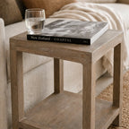 Driftwood Side Table in weathered pine with coastal warmth; glass of water atop a coastal book.