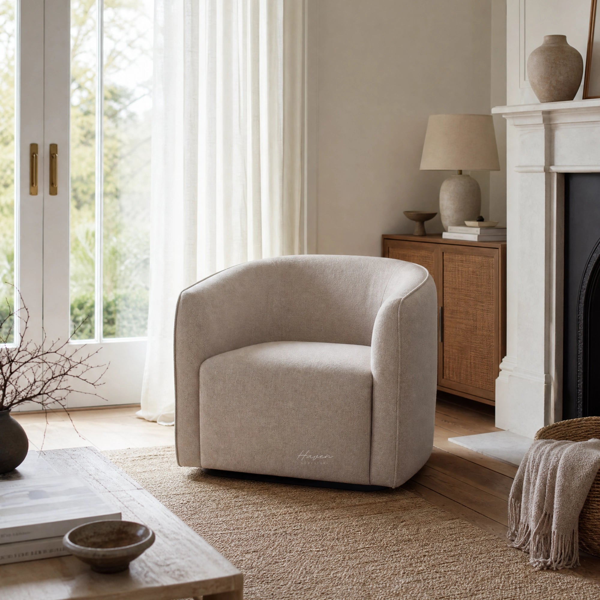 Annika Swivel Chair with a soft curved silhouette in beige upholstery beside a fireplace.