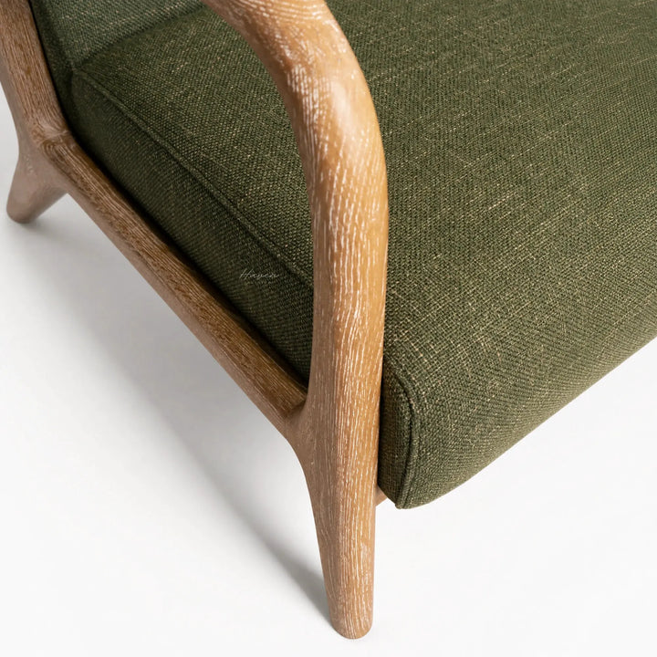 Tairua Lounge Chair in Seagrass with limewashed oak frame and textured green upholstery.