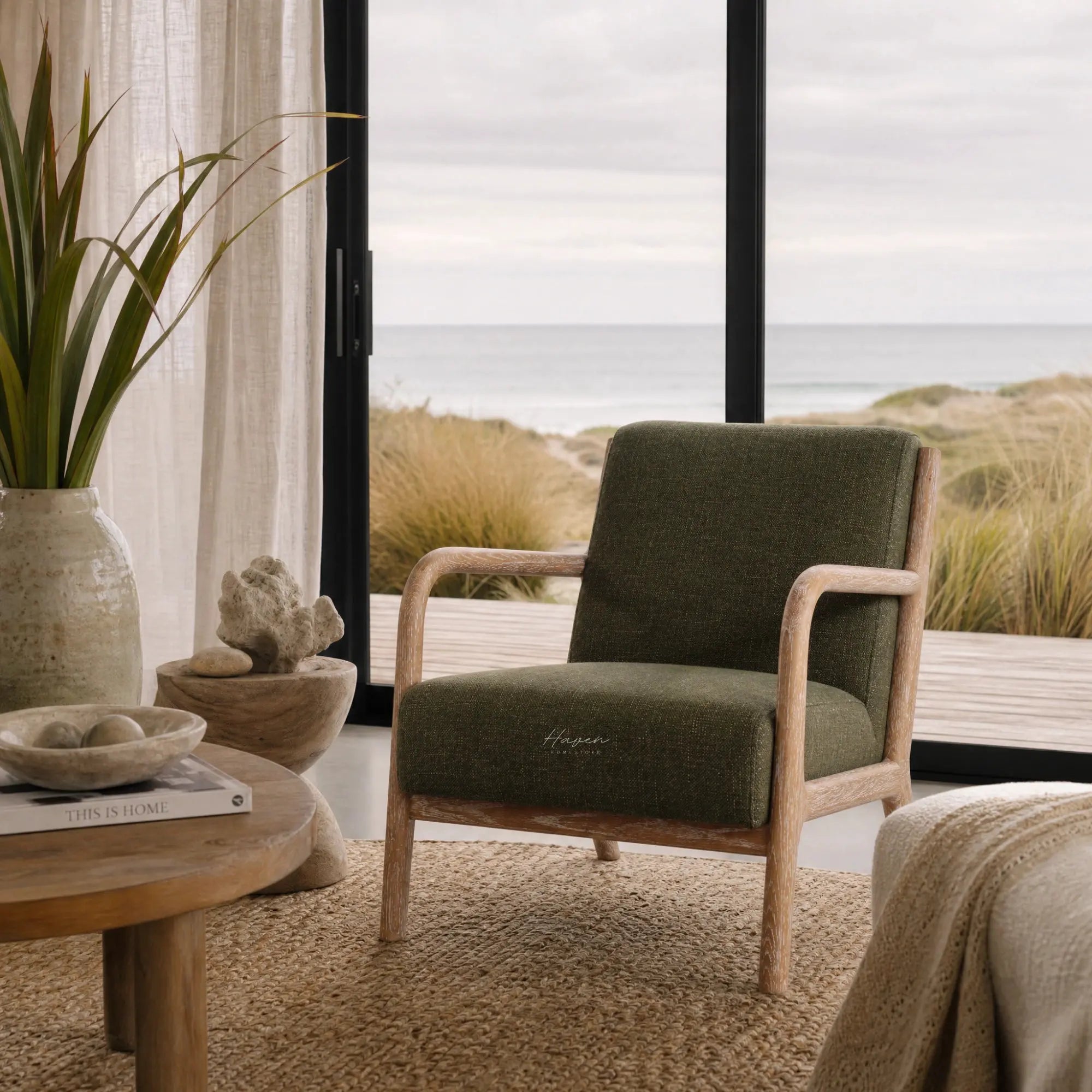 Tairua Lounge Chair in Seagrass with limewashed oak frame beside coastal window