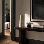 Line Vase: hand-thrown terracotta with bold painted lines on a dark wood console in a calm living room.