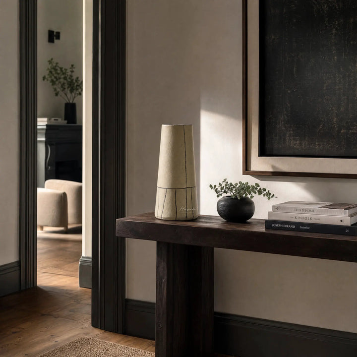 Line Vase: hand-thrown terracotta with bold painted lines on a dark wood console in a calm living room.