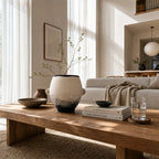 Himari Vase in terracotta with branches on a wooden table in a warm Japandi living room.