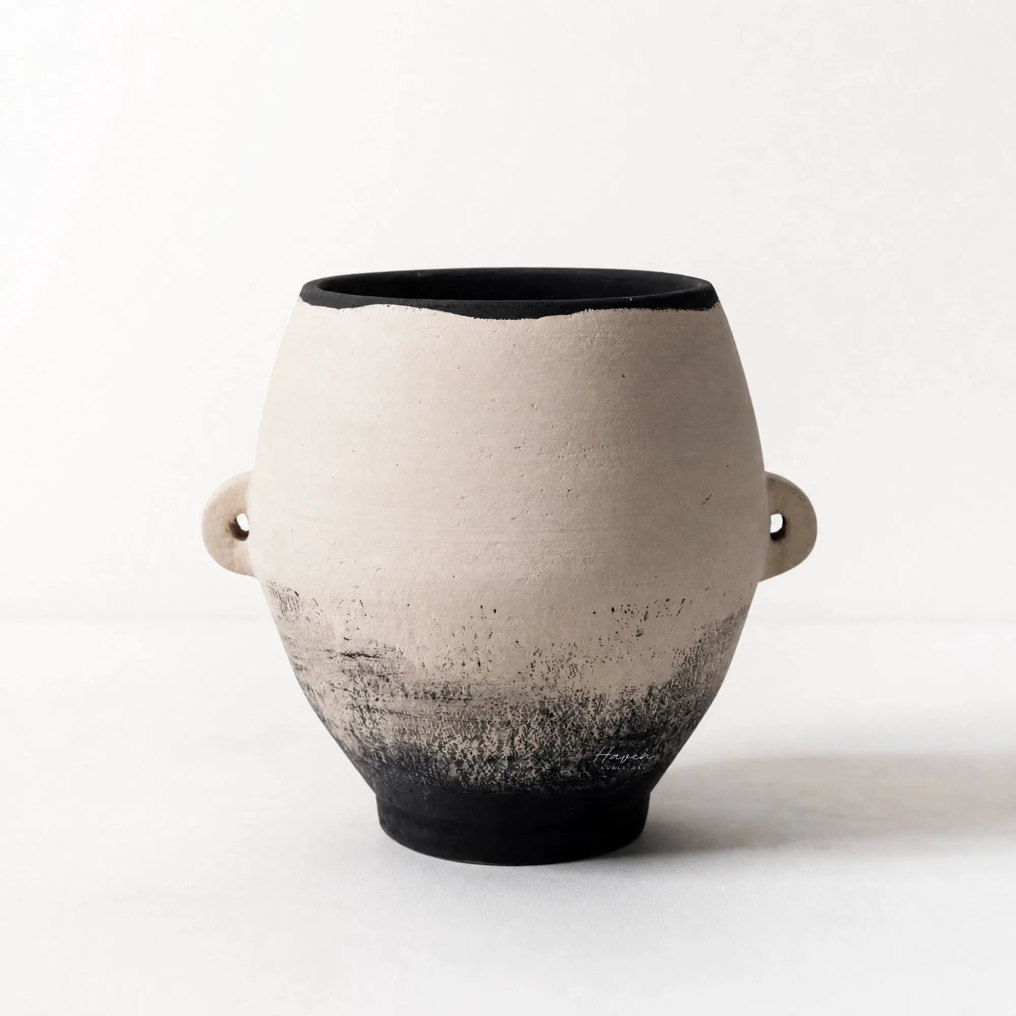 Himari Vase in hand-finished terracotta with a black rim, warm earthy tones, and a sculptural Japandi form.