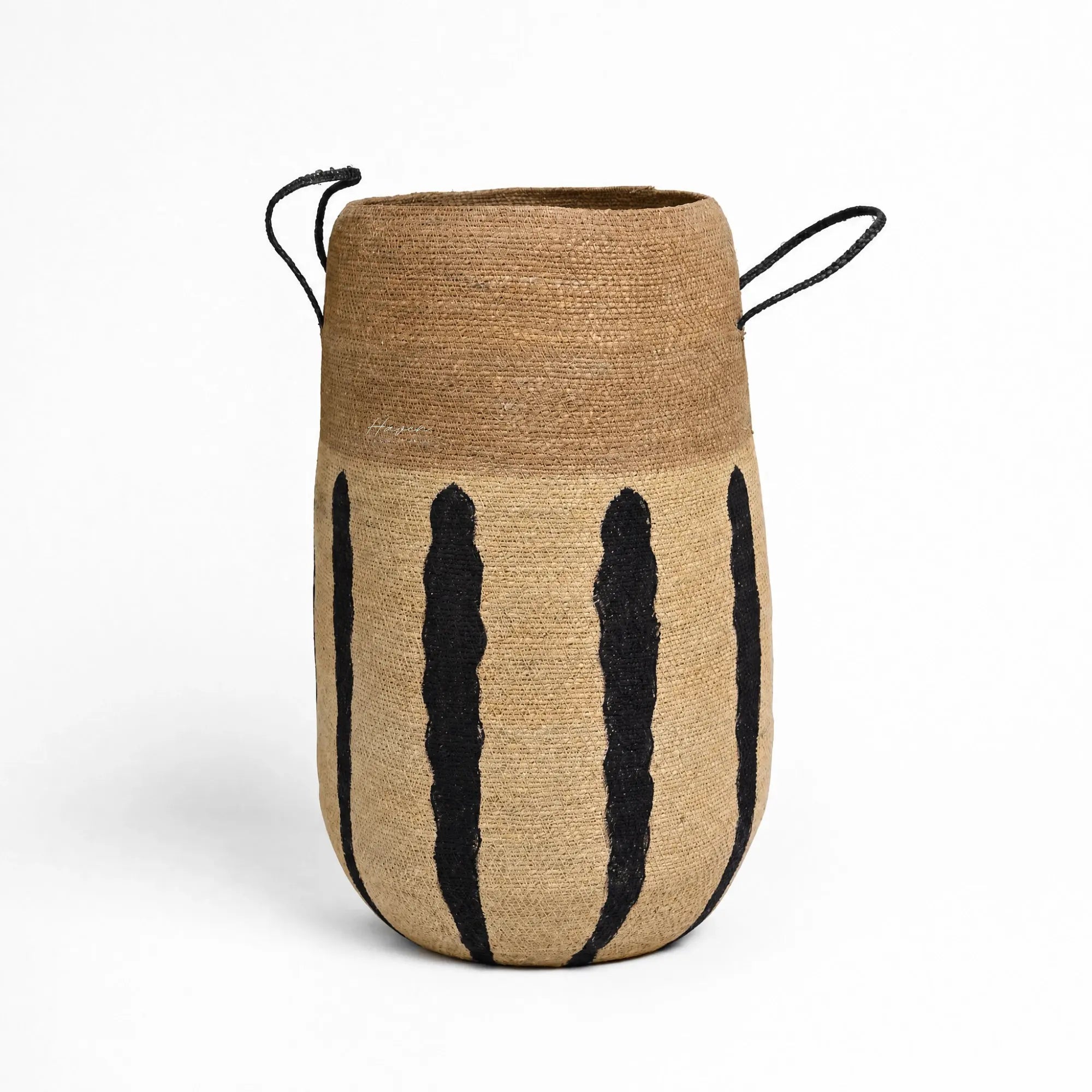 Aditi Basket handwoven from natural seagrass with bold black stripes and black cord handles.