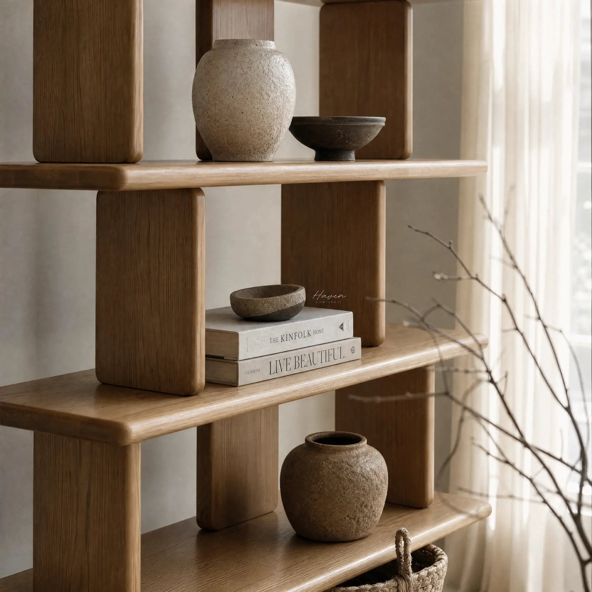 Jansen Shelving Unit in natural timber with open shelves for books and ceramic vessels.