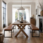 Pure Sabina benches with buffalo leather seats and matte black metal frames at a rustic dining table.
