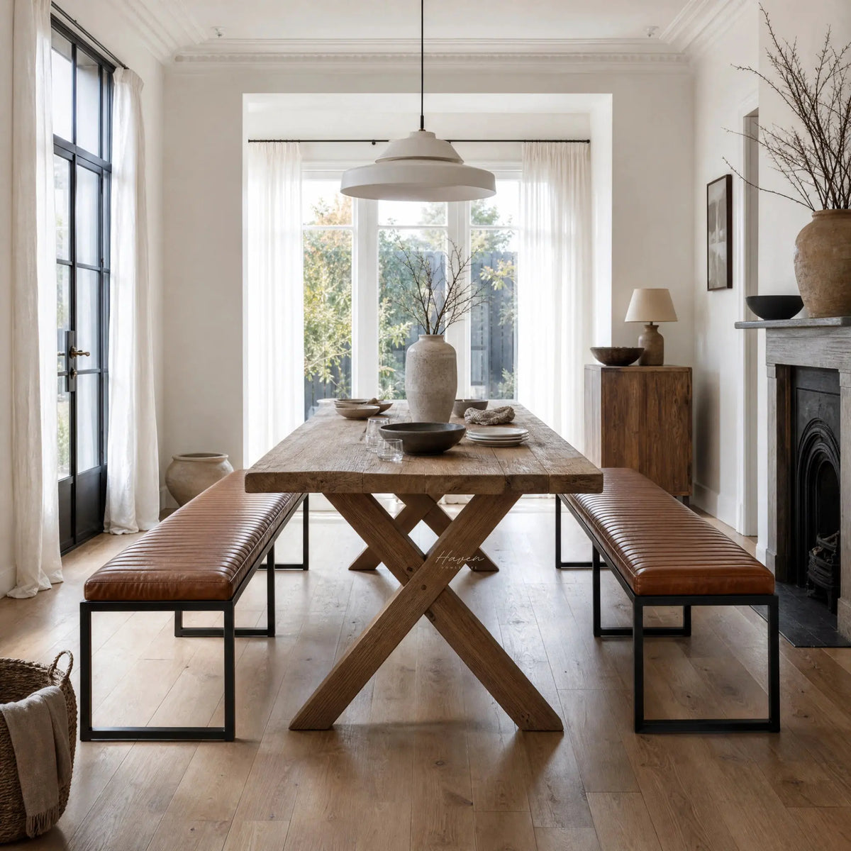 Pure Sabina benches with buffalo leather seats and matte black metal frames at a rustic dining table.