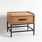 Atlas bedside table in warm oak with a black powder-coated metal frame and a generous drawer