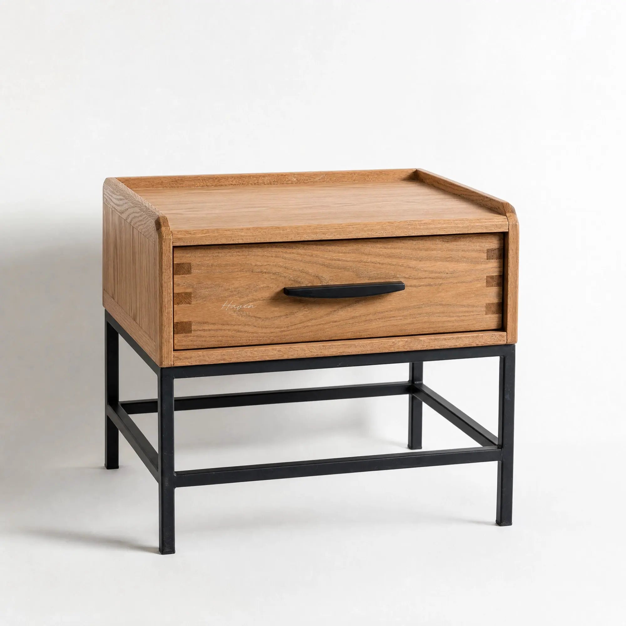 Atlas bedside table in warm oak with a black powder-coated metal frame and a generous drawer