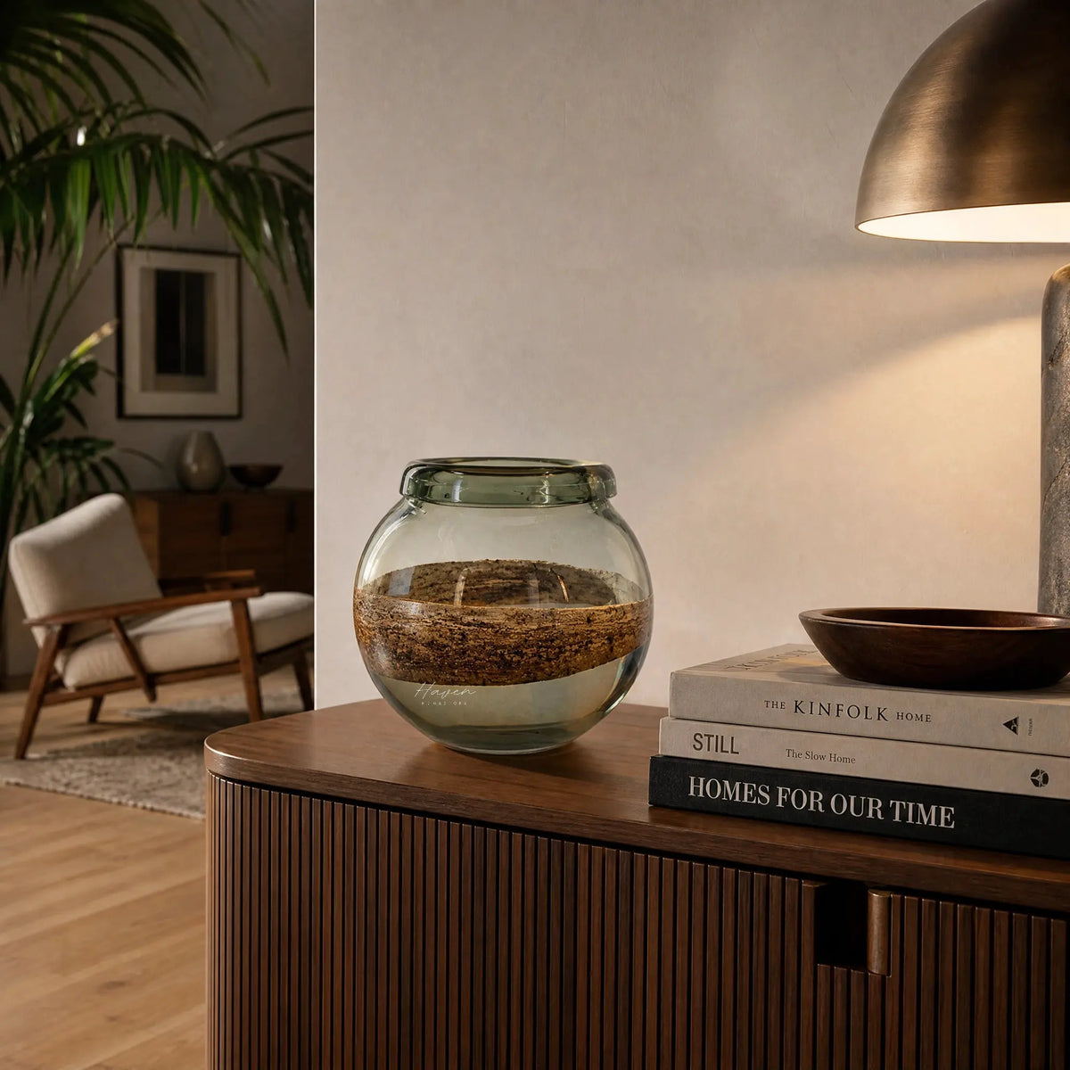 Desert Vase - Bowl, a layered glass vase with cork band on a round wooden table in a cozy living room.