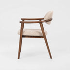 Aster Dining Chair with solid ash frame and beige upholstered seat, Japandi-inspired curved silhouette.