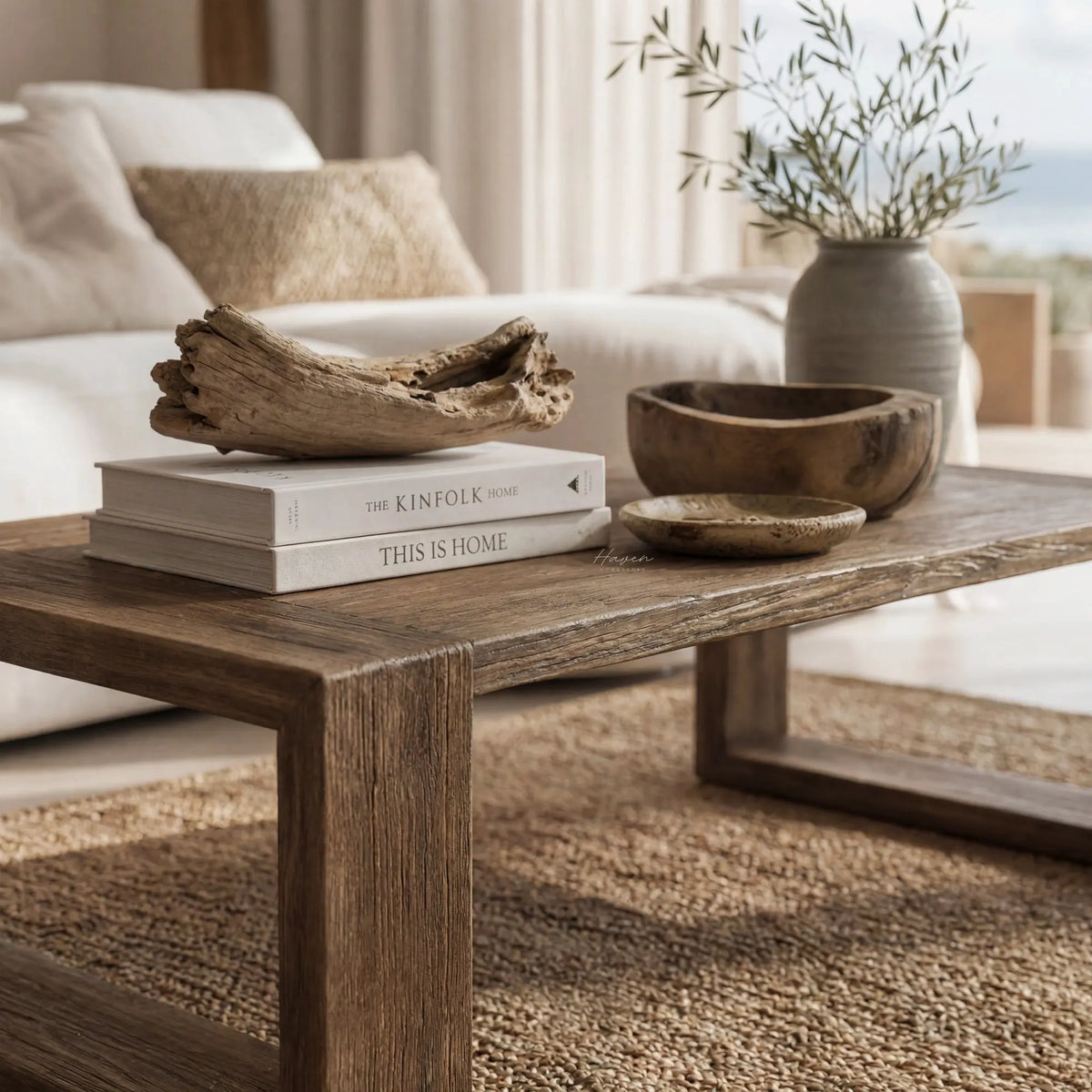 Estuary Coffee Table in a coastal living room, shown with reclaimed elm, driftwood centerpiece, and soft neutral decor.
