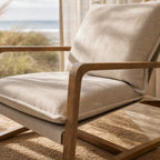 Tide Lounge Chair - Sand with solid oak frame and stone-washed cotton cushions in a coastal, sunlit room.
