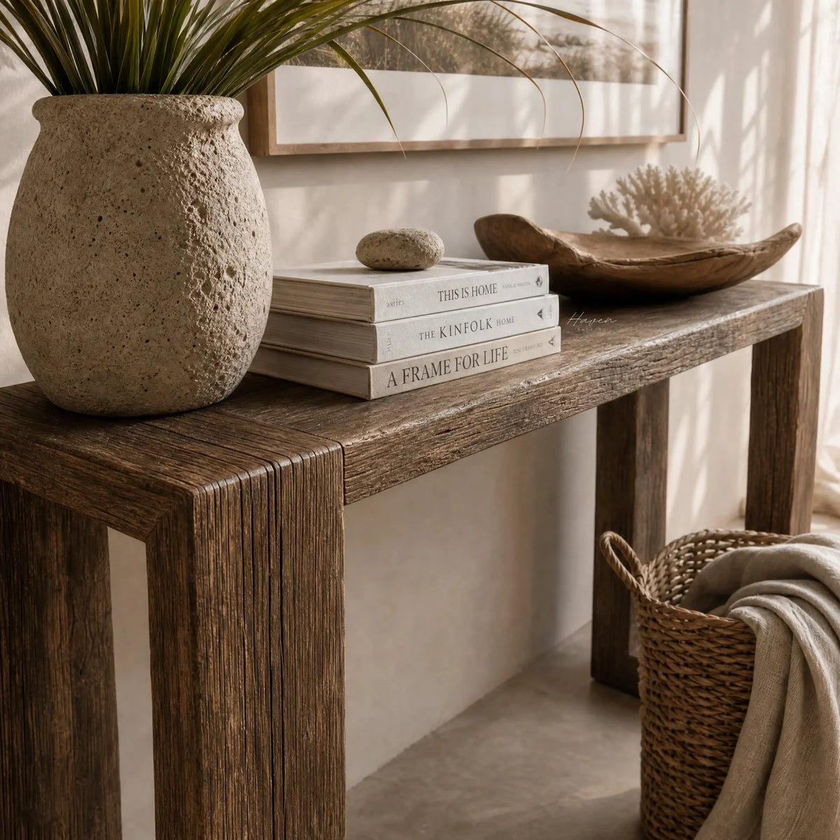 Estuary Console in solid reclaimed elm with rich grain and weathered textures, paired with plants and books.