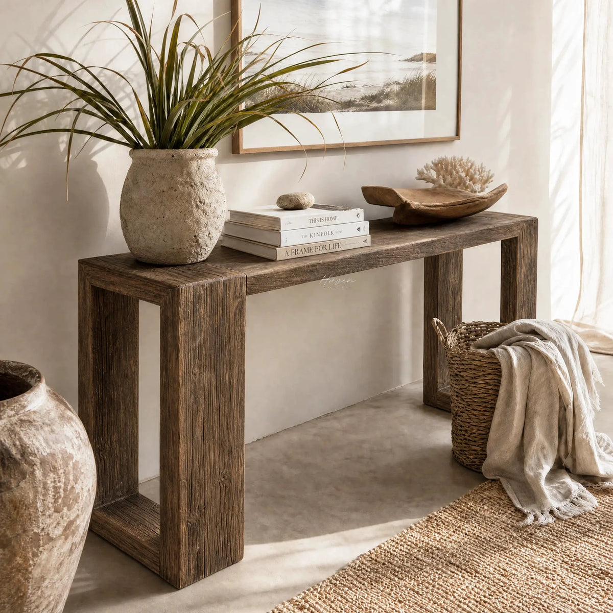 Estuary Console in solid reclaimed elm on a rustic table, paired with plant, books, and woven rug.