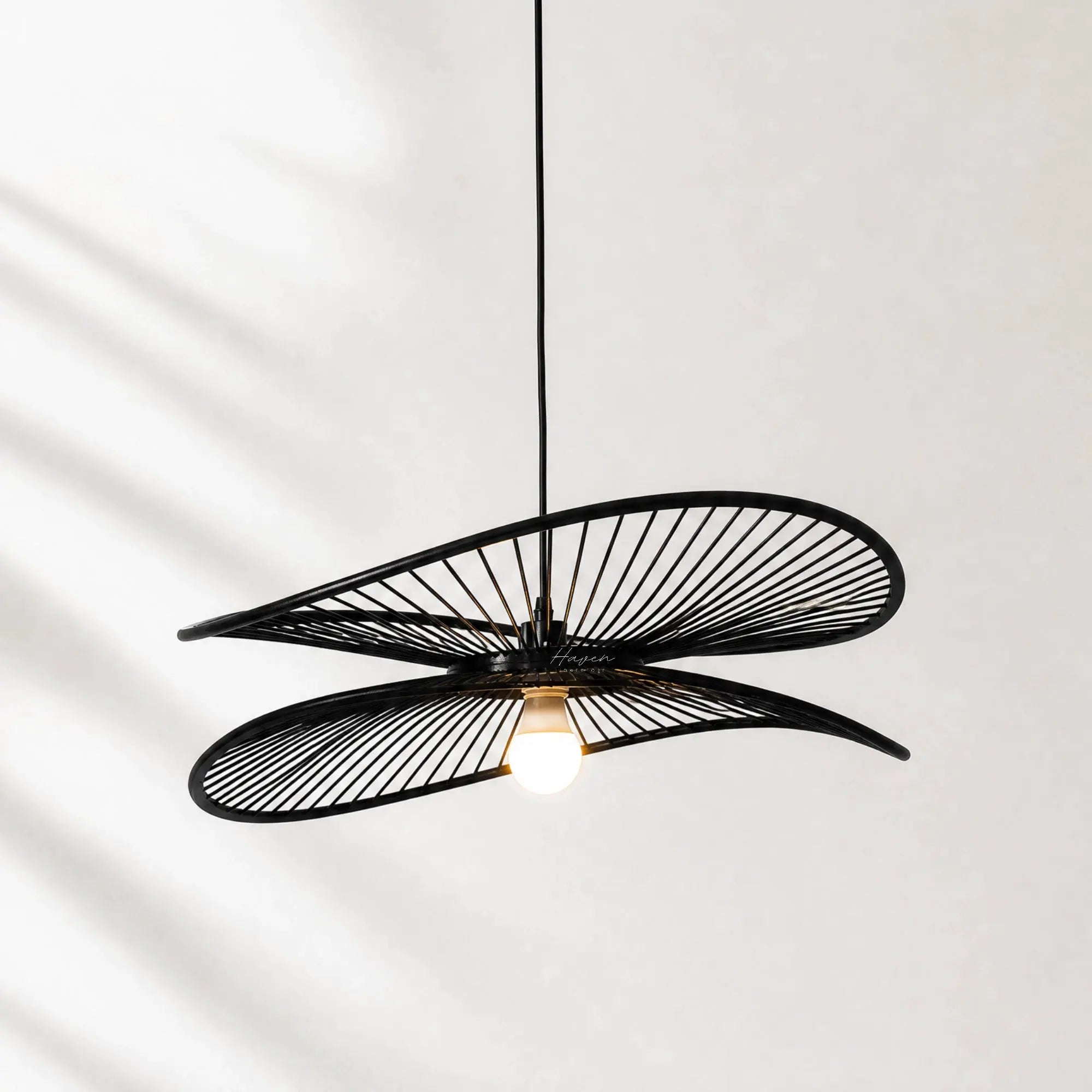 Halo Pendant Light featuring layered black circular hoops, a sculptural hanging fixture with a warm, diffused glow.