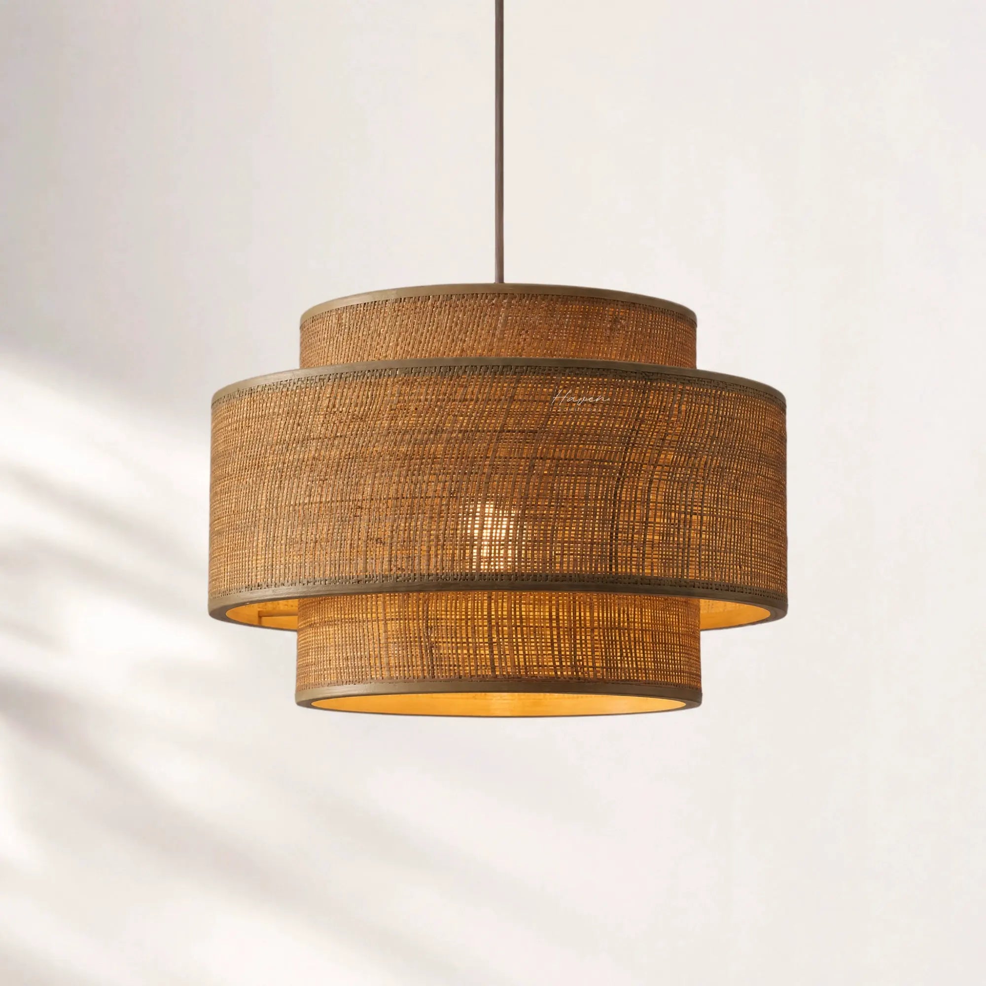Loom Pendant Light with layered bamboo woven shades, hanging from a slim cord, warm Japandi-inspired glow.
