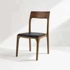 Ellison Dining Chair - Walnut with solid American Ash frame and black cowhide seat.