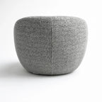 Ingrid Swivel Chair Frost close-up of textured grey fabric with a vertical seam and rounded upholstery.