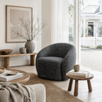 Ingrid Swivel Chair Basalt, Nordic-inspired curved silhouette with textured poly-mix upholstery in a cozy living room.