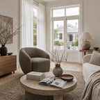 Ingrid Swivel Chair - Tundra in textured upholstery with a rounded silhouette in a sunlit Nordic living room.