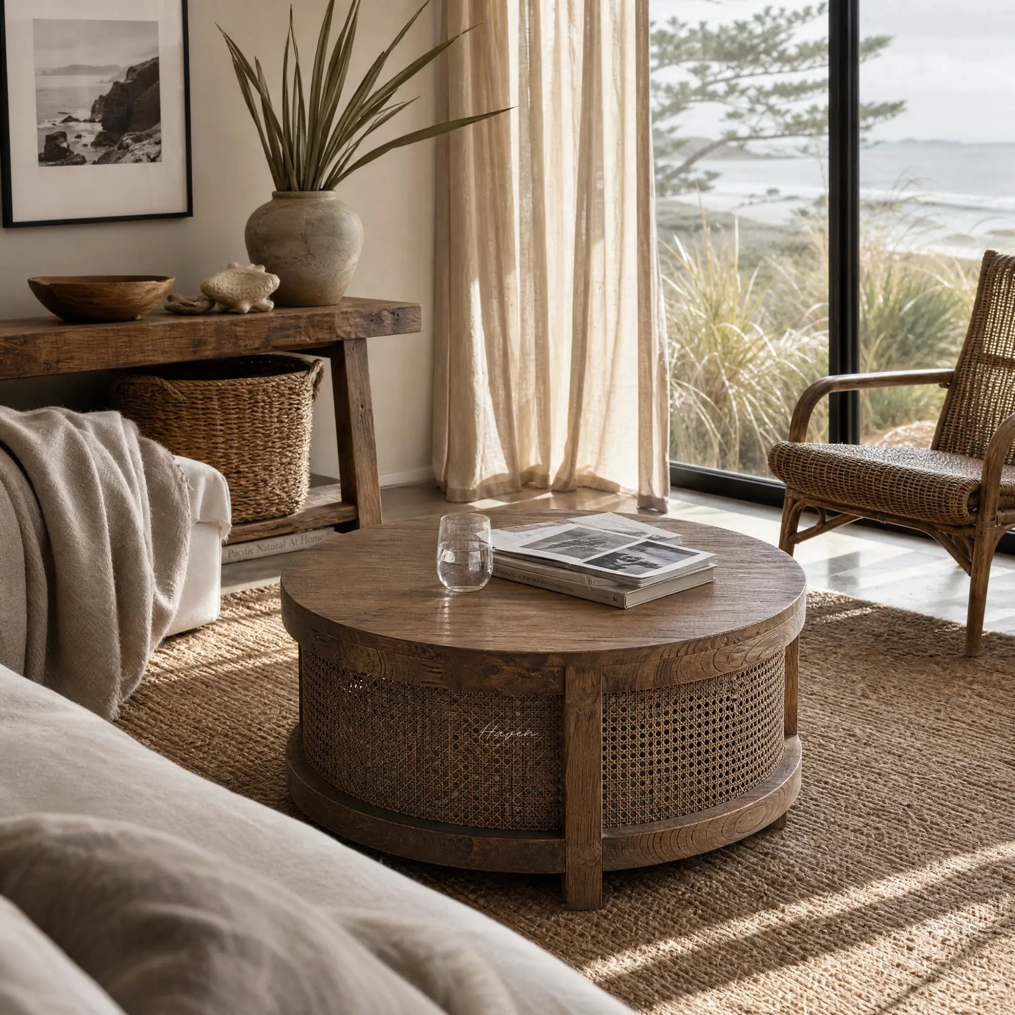 Ubud Coffee Table in bleached elm with handwoven rattan, round centerpiece in a cozy living space.