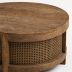 Ubud Coffee Table with a bleached elm top and handwoven rattan weave, warm round silhouette inviting conversation.