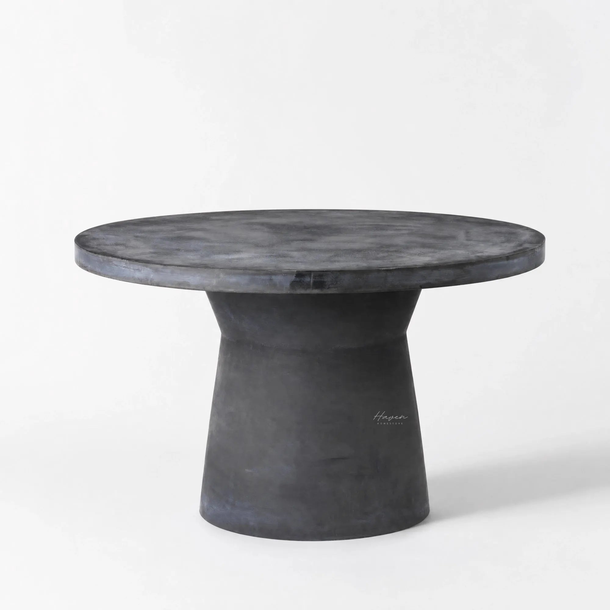 Broste®️ Outdoor Dining Table in fiberclay, round top with sculptural pedestal, concrete-like finish.