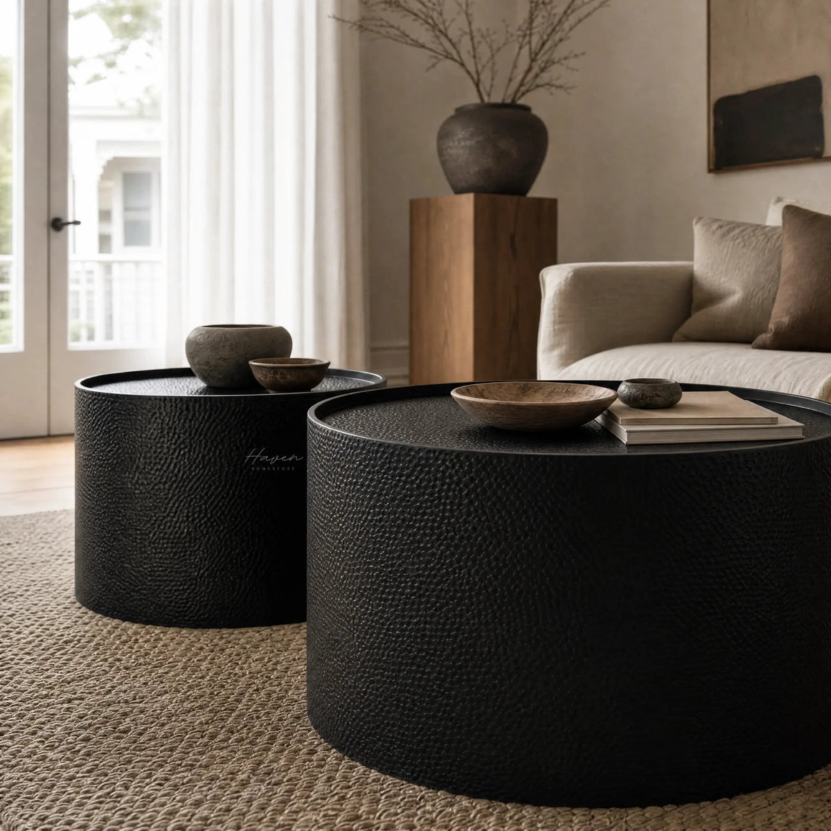 Daven Coffee Table Set/2: two textured iron Scandinavian-inspired nesting tables in a neutral living room.