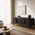 Kuro Slatted Sideboard in ebony-washed oak with slatted doors in a neutral, minimalist living room.