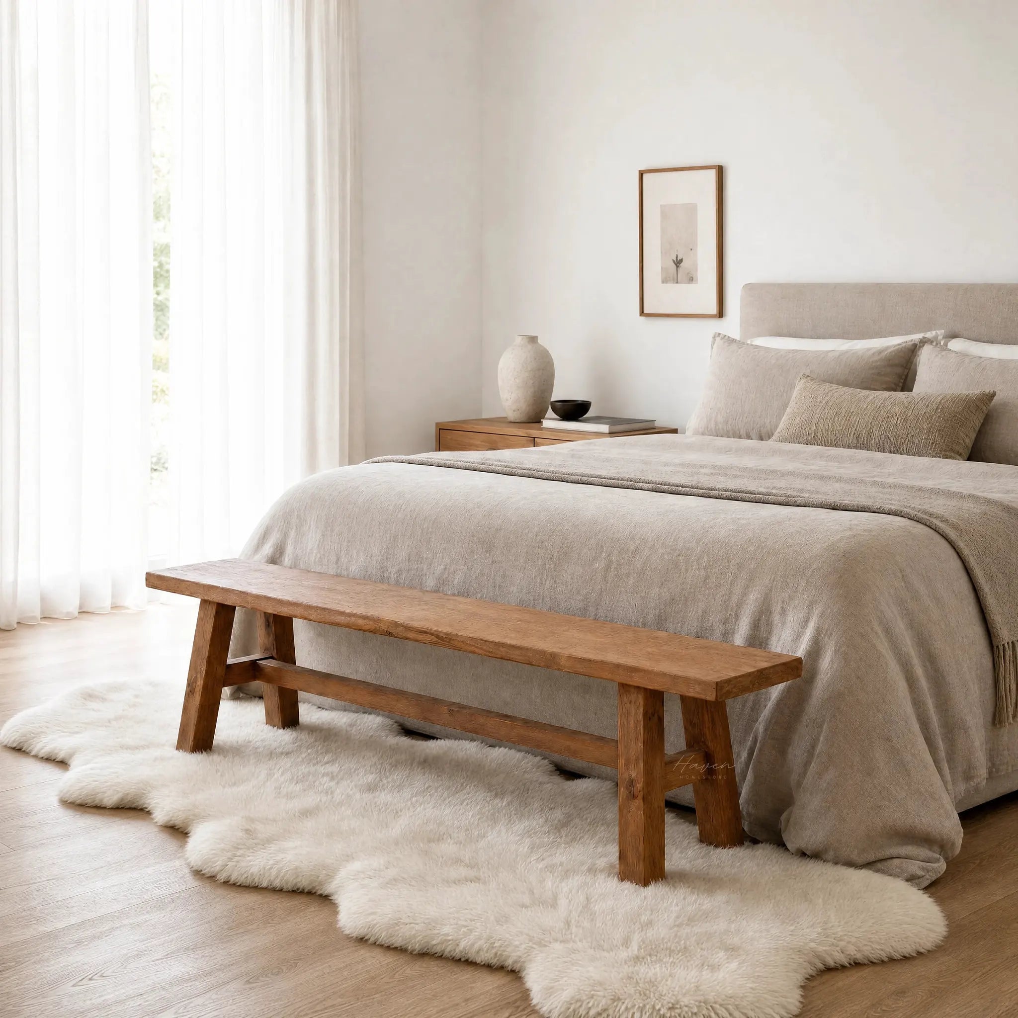 Reclaimed Wood Bench 160, elm, at foot of bed in a serene beige bedroom.